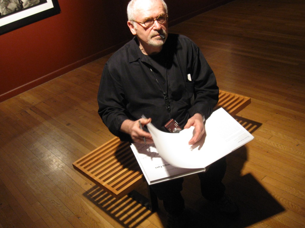 Abe Franjdlich signing Mort Epstein's copy of Penelope's eyes