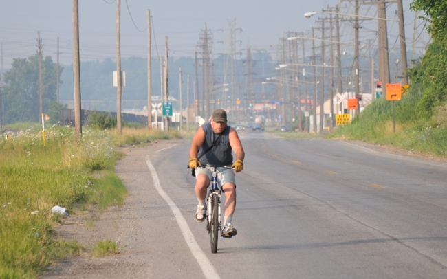 Bicyclist in Cleveland Flats during unhealthy smog conditions