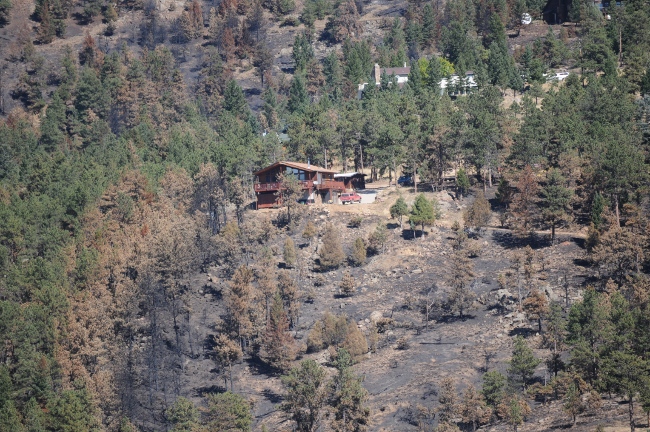  Fourmile Canyon Wildfire, West of Boulder, Colorado, September 2010 - home on hillside spared from fire