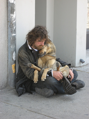 homeless_man_cuddling_dog.jpg