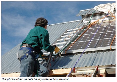 PV Panels Being Installes On A Workshed Roof