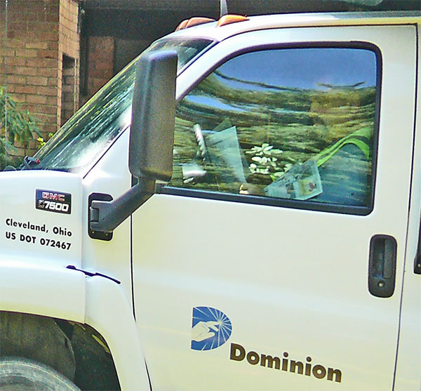 dominion gas worker in truck reading newspaper