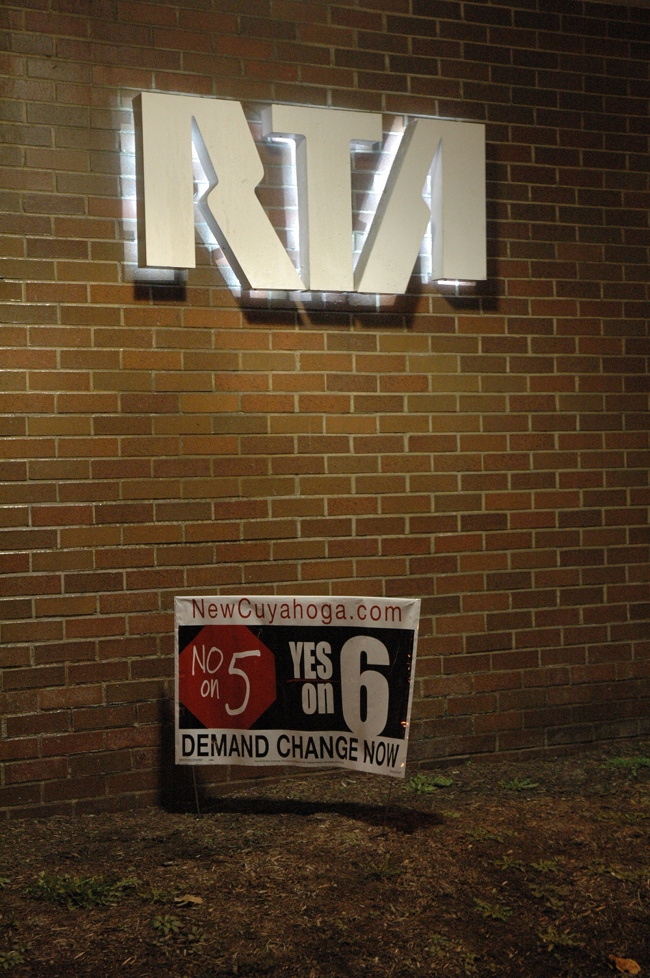 Illegal Issue 6 sign below RTA sign at RTA station in Shaker Square, Cleveland