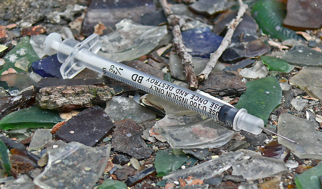 syringe used on broken glass society unwinding